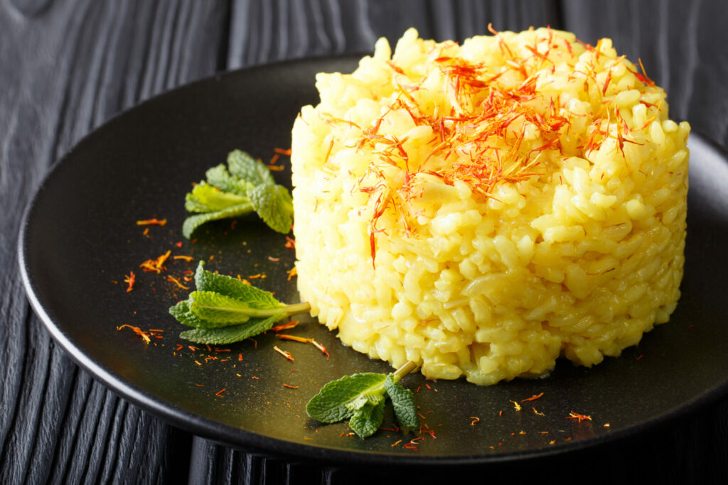 Vegetarian Italian food: risotto with saffron and mint (Risotto alla milanese) closeup. horizontal